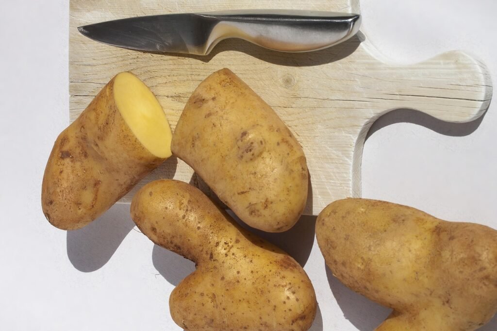 potato, cut open for potato salad, knife, wooden board, old, heart, vegetables, nourishment, love, food, bio, nature, symbol, fresh, heart shape, potato heart, raw, uncooked, tuber, strength, romantic, connectedness, love greeting, emotion, harmony