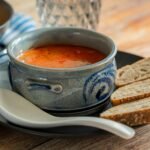 Delicious East European solyanka soup served with bread, perfect for a cozy meal.