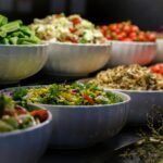 A colorful assortment of fresh salads and vegetables in ceramic bowls. Perfect for healthy food photography.
