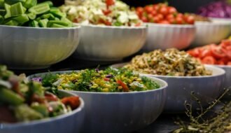 A colorful assortment of fresh salads and vegetables in ceramic bowls. Perfect for healthy food photography.