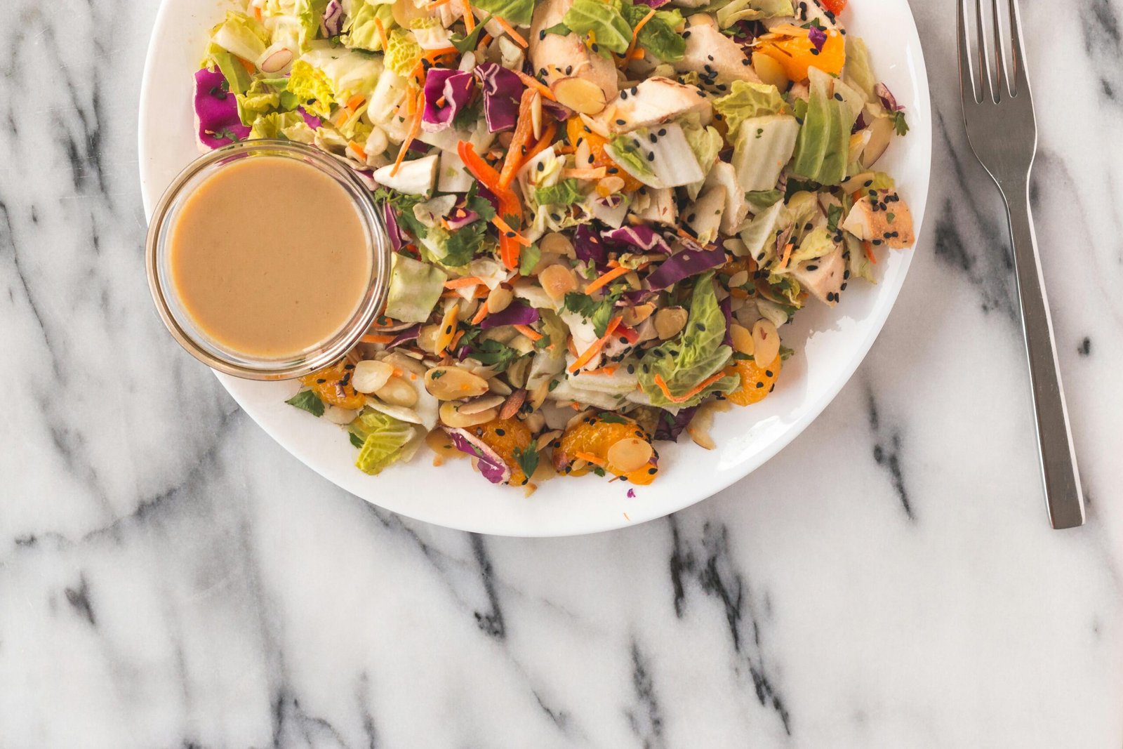 A vibrant Asian salad with fresh ingredients and tangy sauce, perfect for a healthy meal.